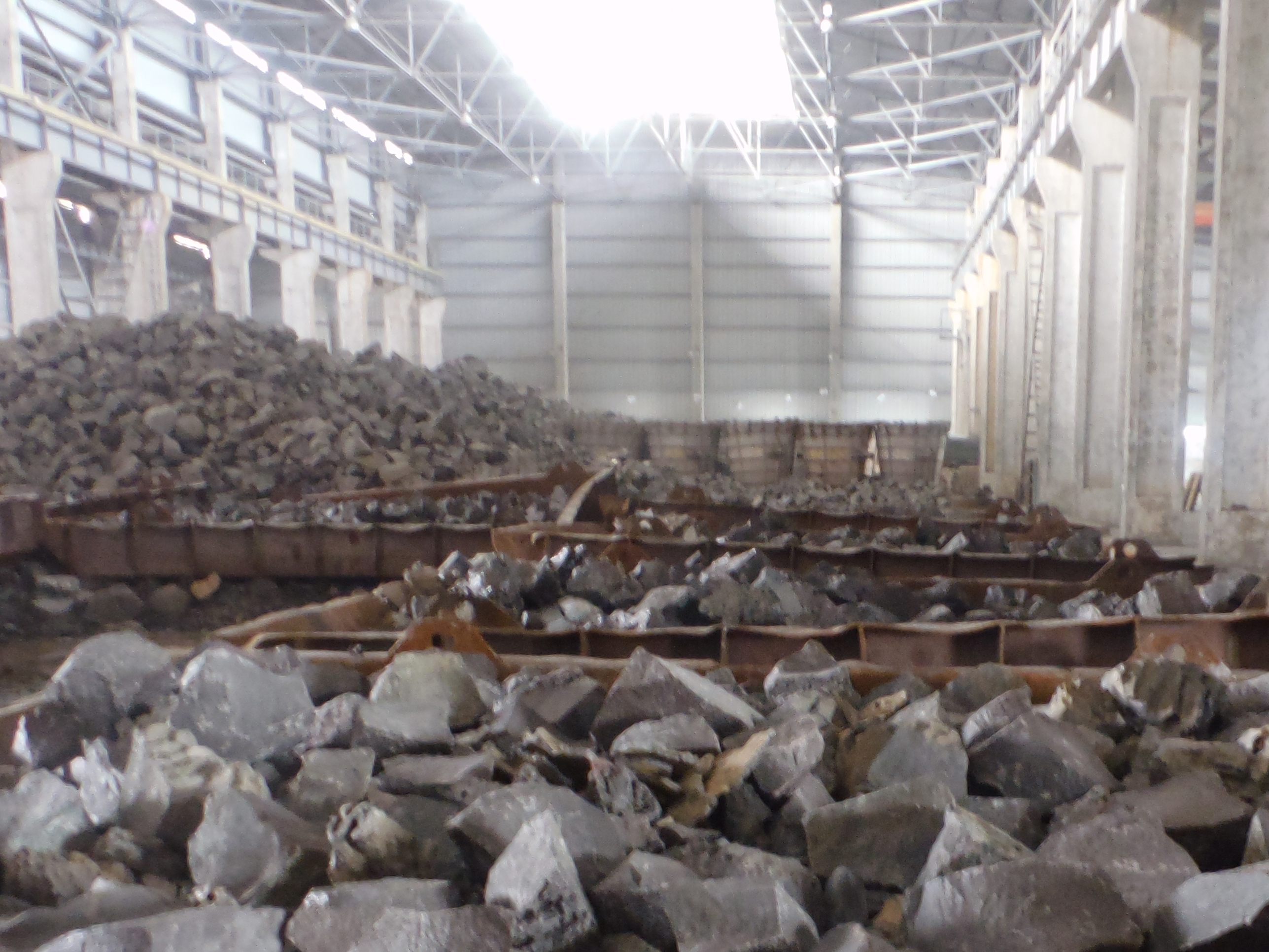 The cold ingots are being broken down by different machines into small sizes for further processing.